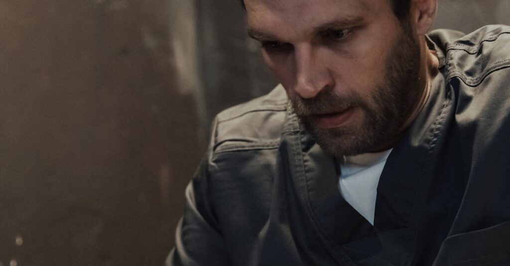 man-reflecting-on-prison