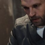 man-reflecting-on-prison